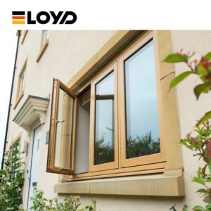 The ELOYD light brown wood-grain double-hung window is equipped with silver handles and is installed within a beige stone window frame. Outside the window, there are green plants.